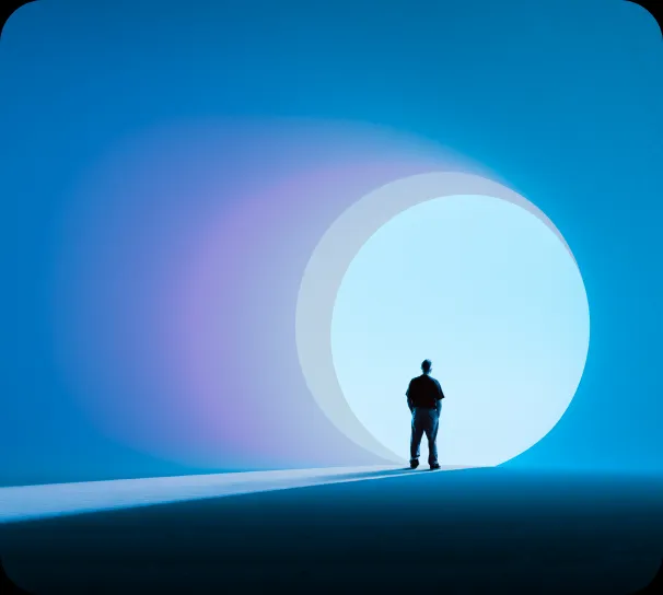 A lone figure silhouetted against a glowing portal